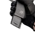 Extended Glock 19 clip in pistol facing left zoomed in on the hand.