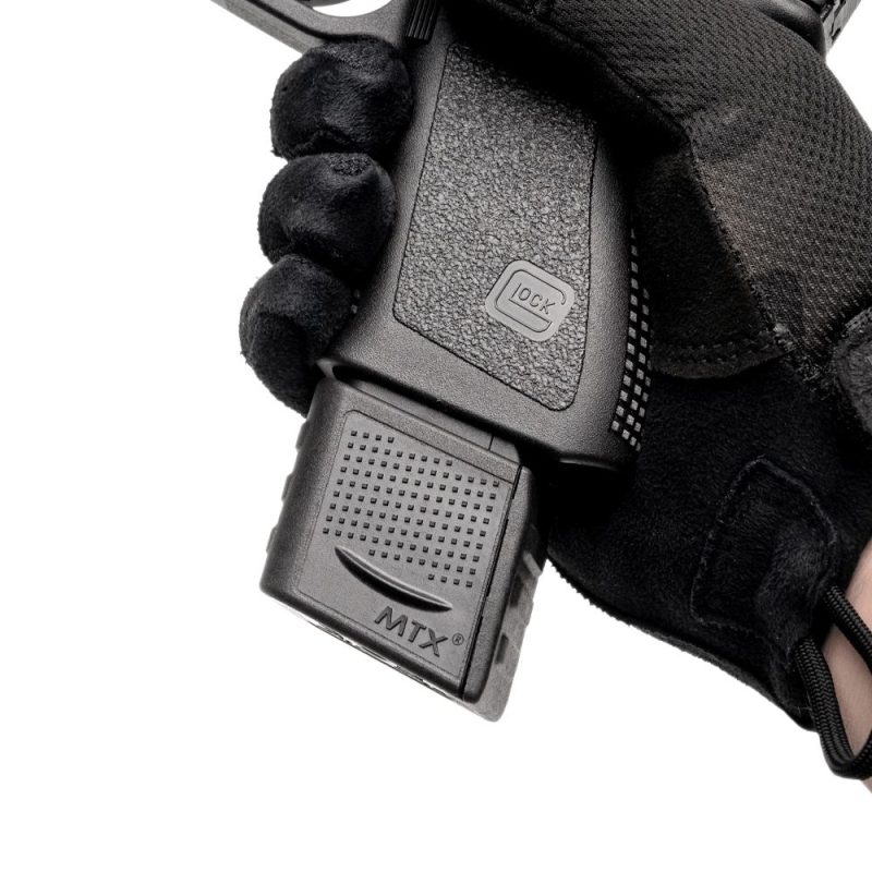 Extended Glock 19 clip in pistol facing left zoomed in on the hand.