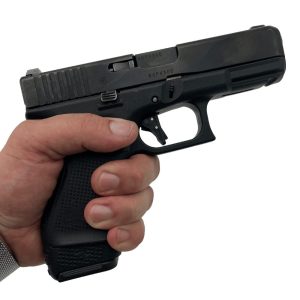 Glock 19 gen5 in hand facing right with extended magazine