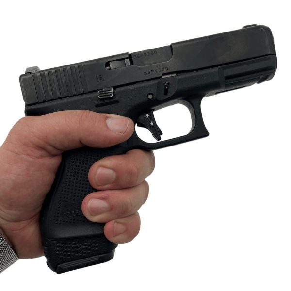 Glock 19 gen5 in hand facing right with extended magazine