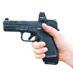 Extended mag for RXM with grip spacer shown in hand in pistol facing left