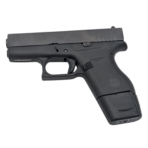 Glock 43 with extended 9 round magazine facing left