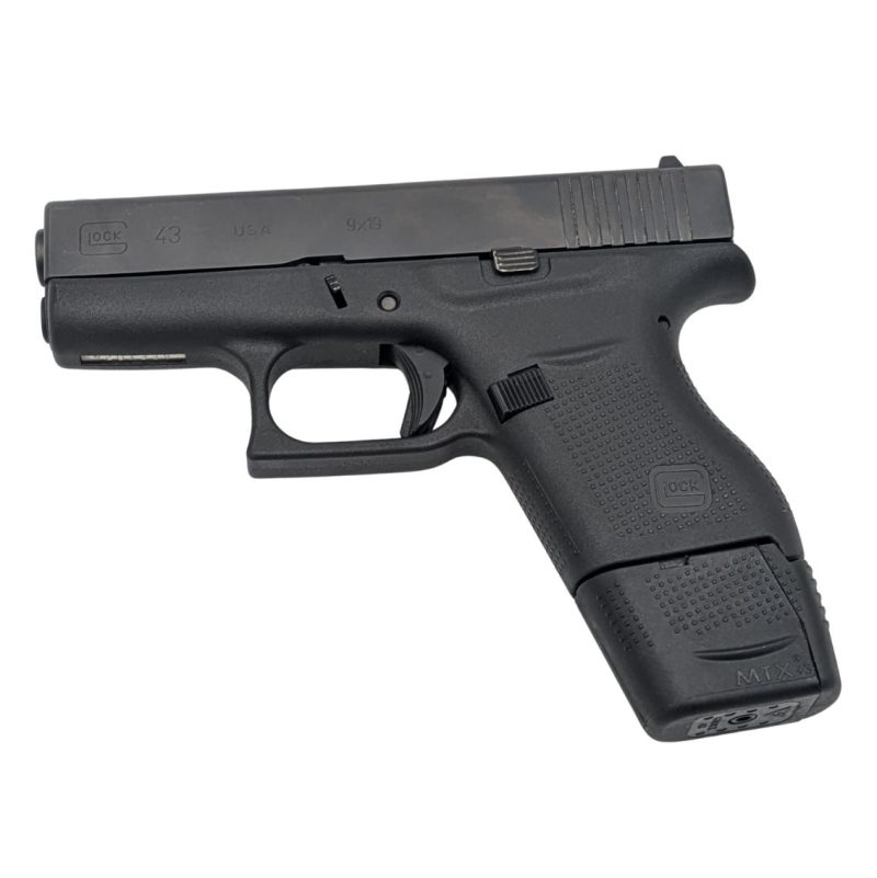 Glock 43 with extended 9 round magazine facing left