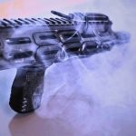 Smoke shown coming through the slots of a hand guard with rail covers in place in black.