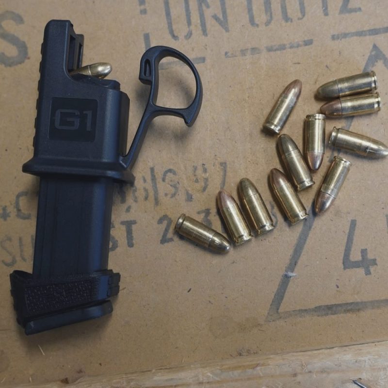 Glock clip loader shown on magazine on top of a table easily loading rounds.