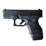 Glock 26 pistol with extended 15 round magazine facing left