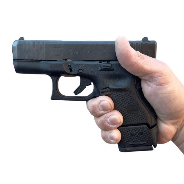 Magazine sleeve for Glock 26 installed and in pistol shown in hand.